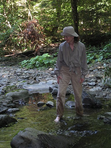 Marilyn wading across a rocky stream